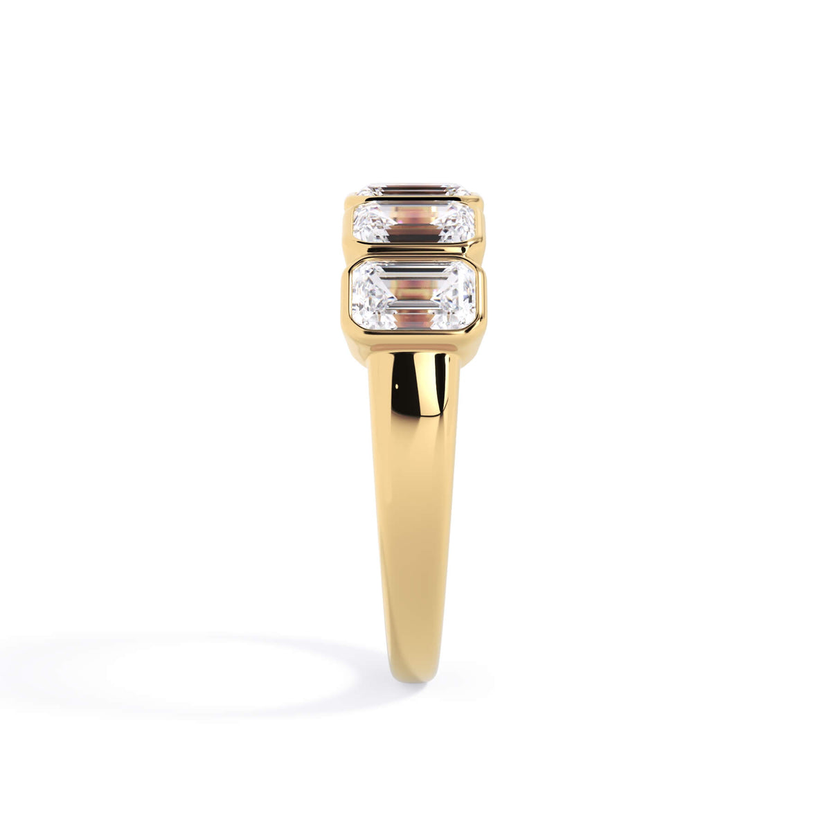 A picture of a five stone diamond wedding ring with emerald cut diamonds that are bezel set in yellow gold on a white background with a side profile view.