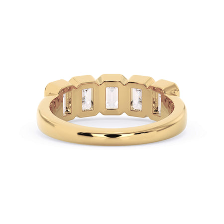 A picture of a five stone diamond wedding ring with emerald cut diamonds that are bezel set in yellow gold on a white background with a view of the underside of the ring.