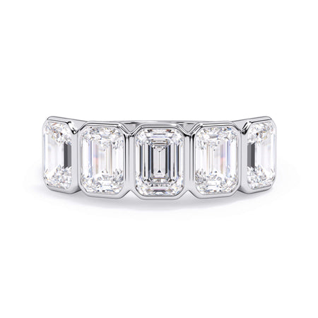 A picture of a five stone diamond wedding ring with emerald cut diamonds that are bezel set in white gold or platinum on a white background with the ring facing forward, lying down.