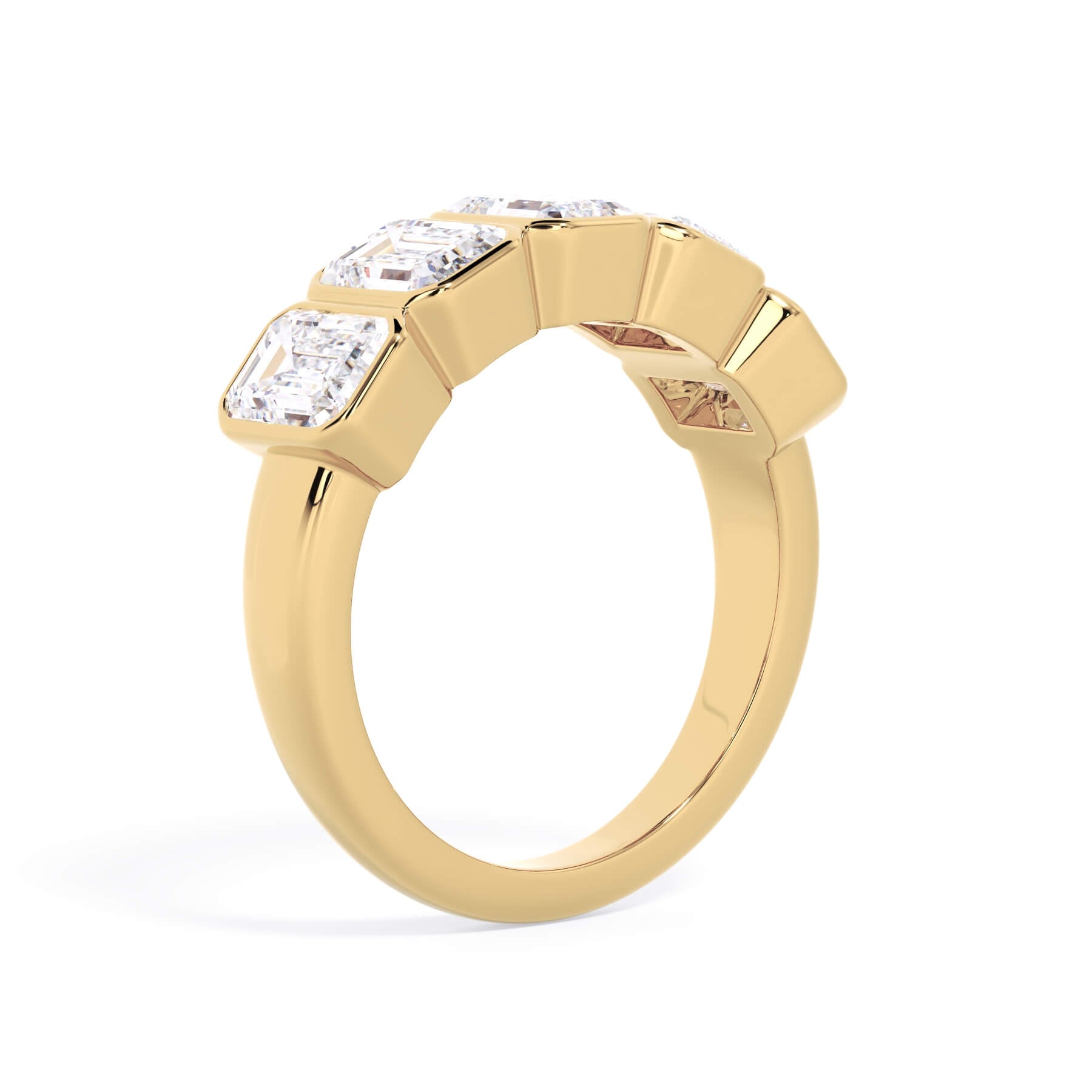 A picture of a five stone diamond wedding ring with emerald cut diamonds that are bezel set in yellow gold on a white background with a slightly angled, through the finger view.
