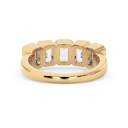 A picture of a five stone diamond wedding ring with emerald cut diamonds that are bezel set in yellow gold on a white background with a view of the underside of the ring.