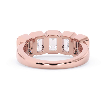A picture of a five stone diamond wedding ring with emerald cut diamonds that are bezel set in rose gold on a white background with a view of the underside of the ring.