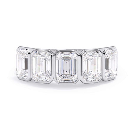 A picture of a five stone diamond wedding ring with emerald cut diamonds that are bezel set in white gold or platinum on a white background with the ring facing forward, lying down.
