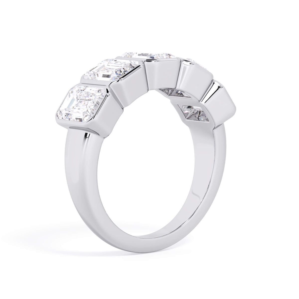 A picture of a five stone diamond wedding ring with emerald cut diamonds that are bezel set in white gold or platinum on a white background with a slightly angled, through the finger view.