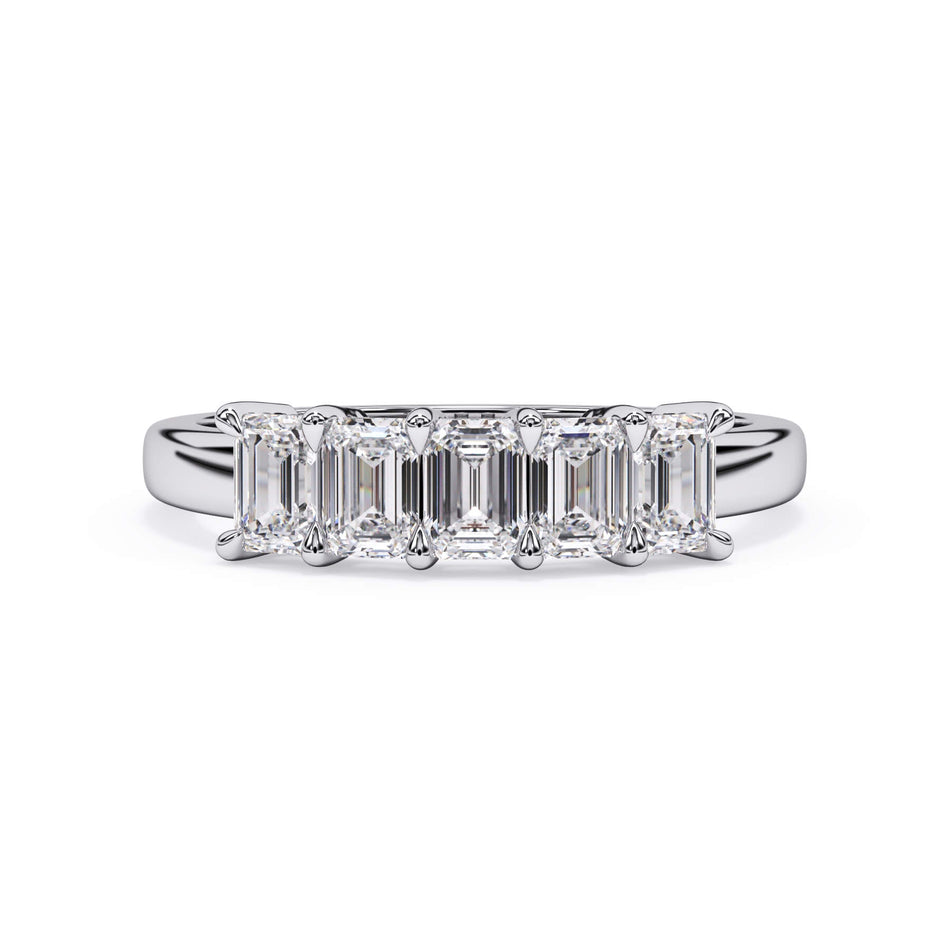 A picture of a five stone diamond wedding ring with emerald cut diamonds that are shared prong set in white gold or platinum on a white background with the ring facing forward, lying down.