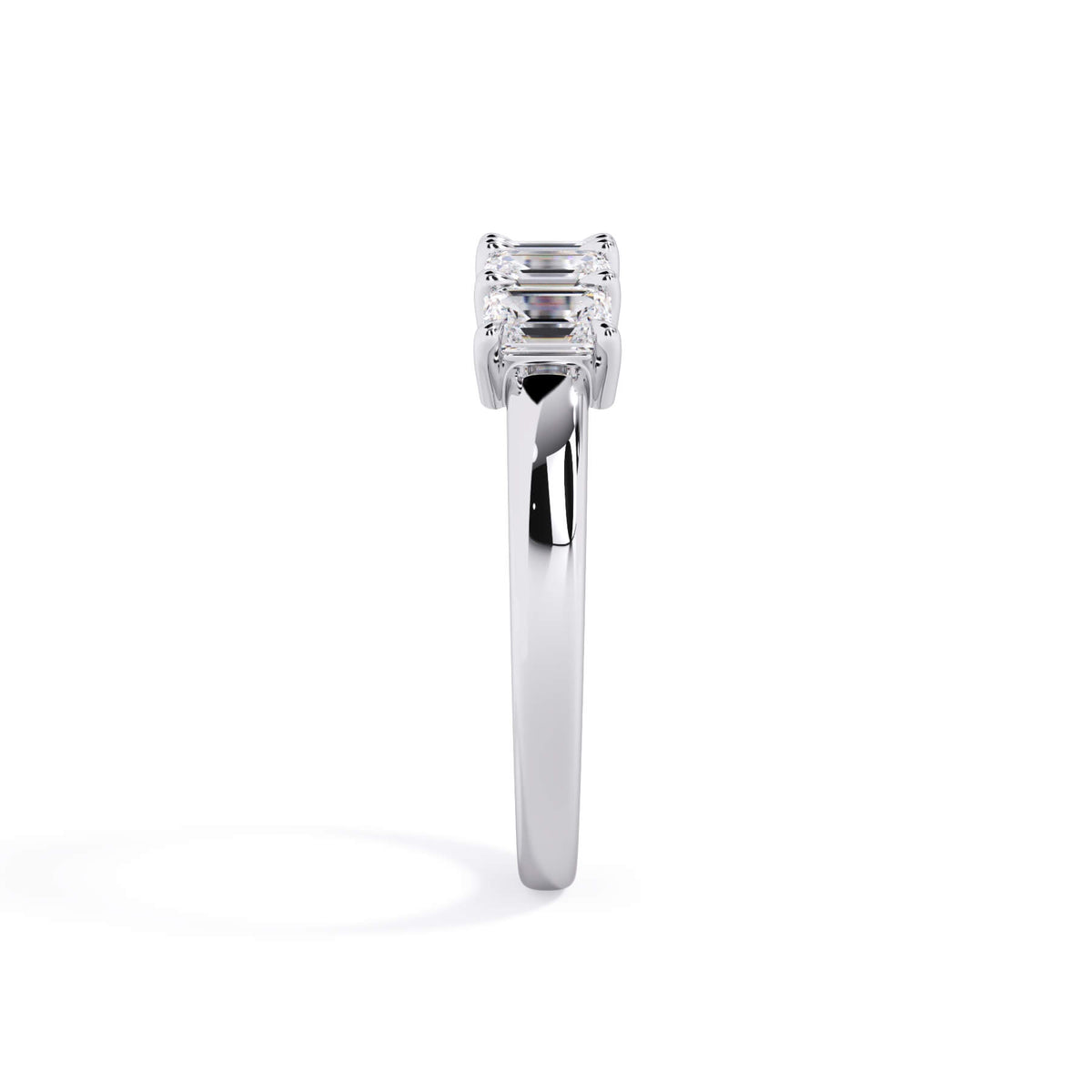 A picture of a five stone diamond wedding ring with emerald cut diamonds that are shared prong set in white gold or platinum on a white background with a side profile view.