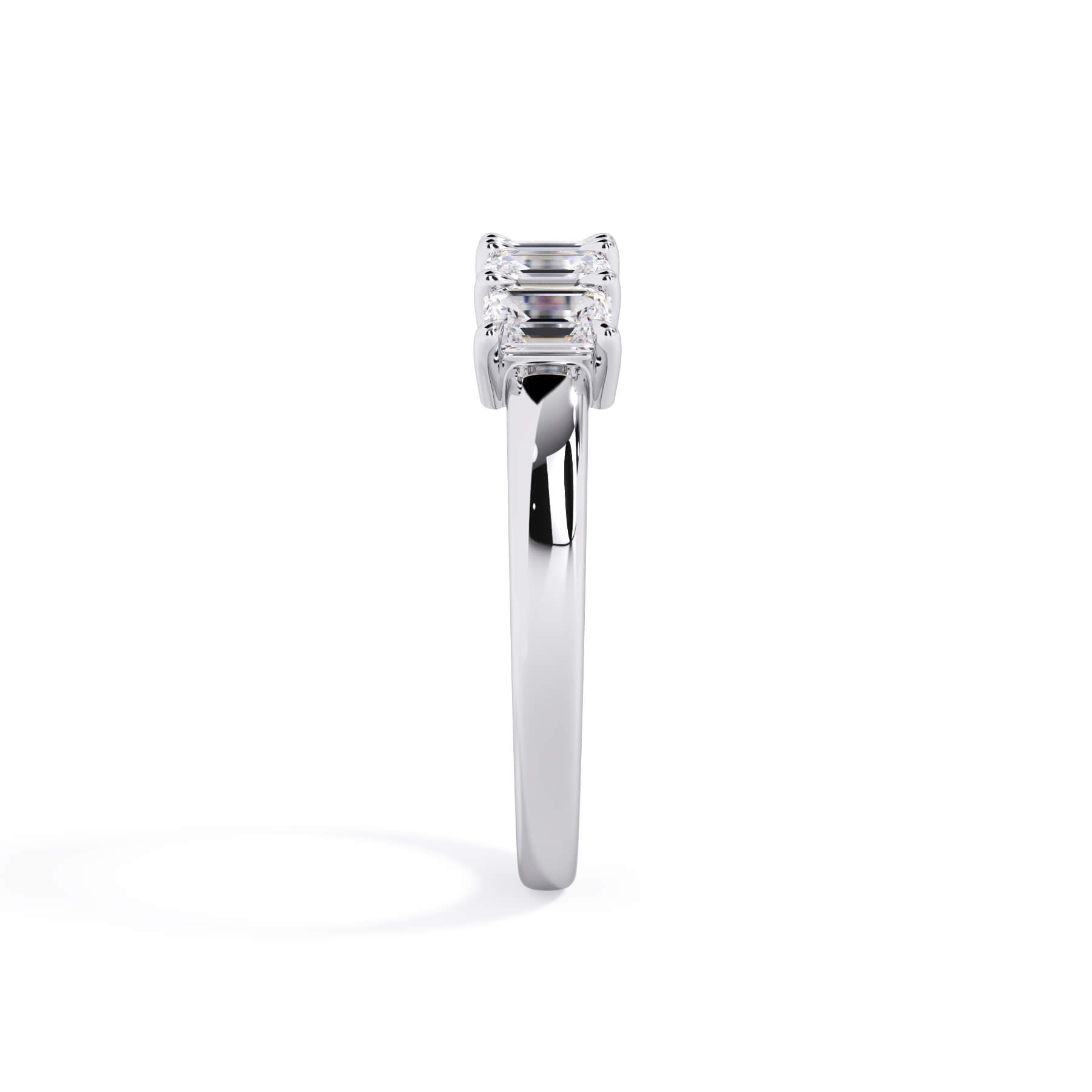 A picture of a five stone diamond wedding ring with emerald cut diamonds that are shared prong set in white gold or platinum on a white background with a side profile view.
