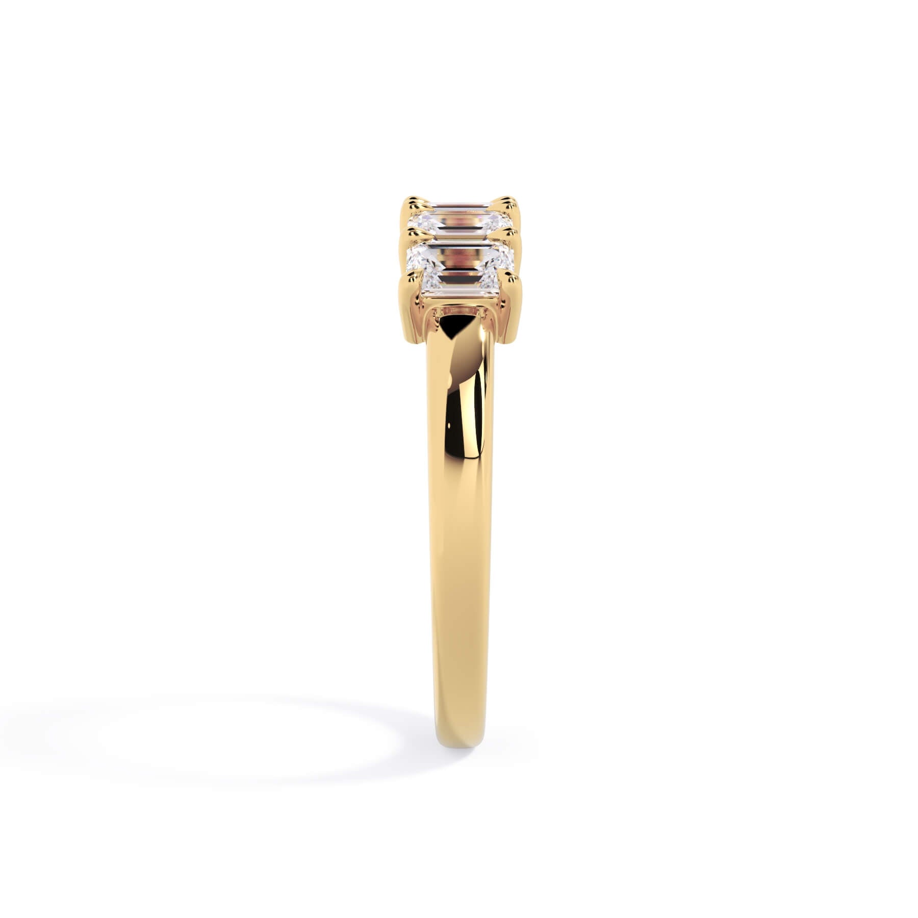 A picture of a five stone diamond wedding ring with emerald cut diamonds that are shared prong set in yellow gold on a white background with a side profile view.