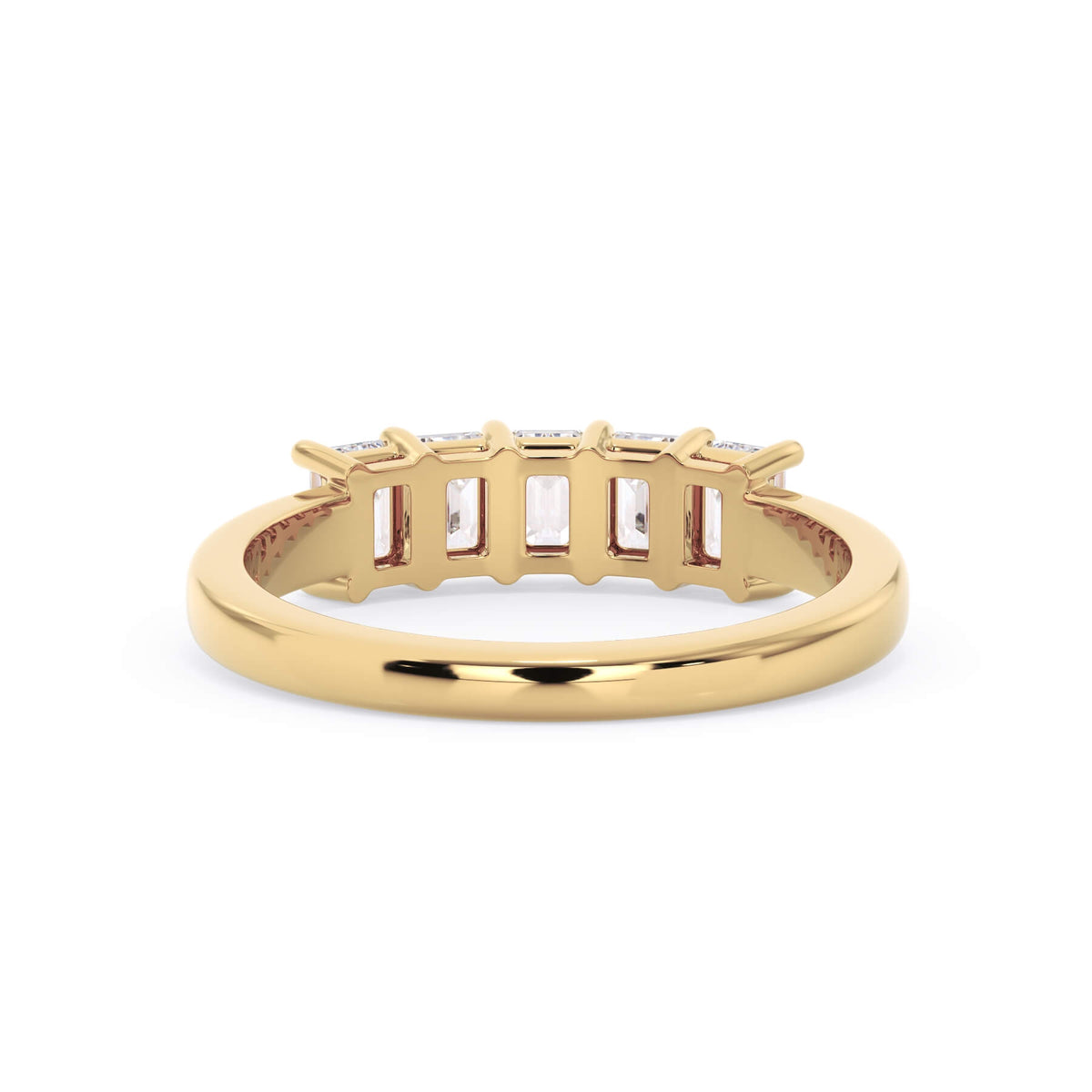 A picture of a five stone diamond wedding ring with emerald cut diamonds that are shared prong set in yellow gold on a white background with a view of the underside of the ring.