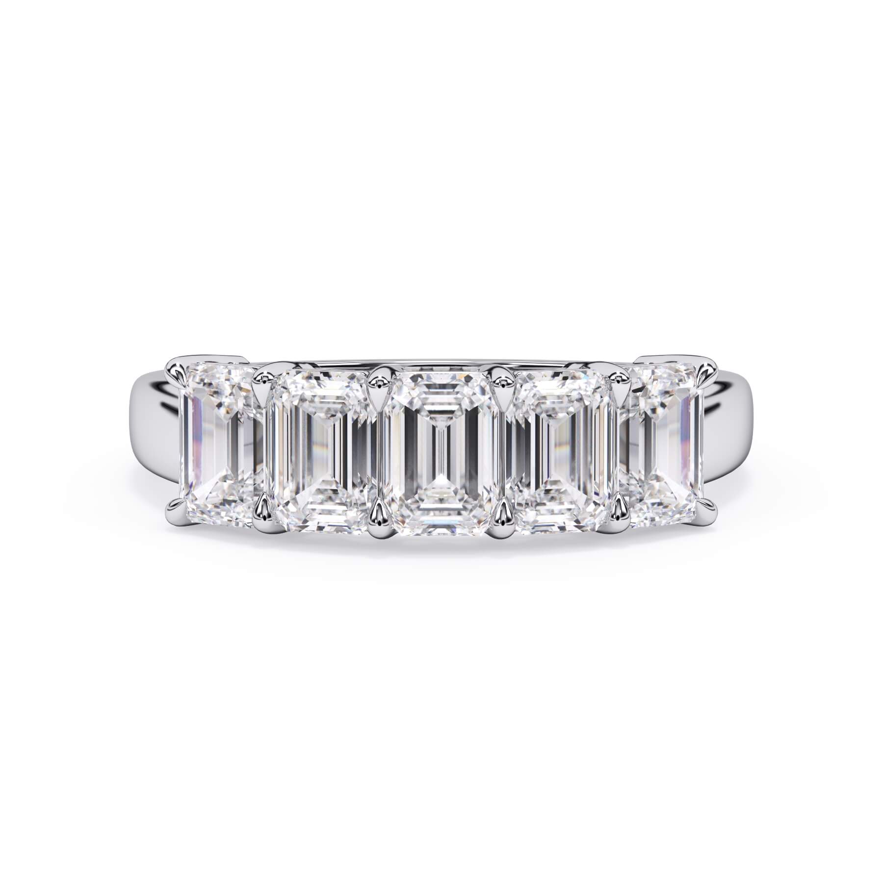 A picture of a five stone diamond wedding ring with emerald cut diamonds that are shared prong set in white gold or platinum on a white background with the ring facing forward, lying down.