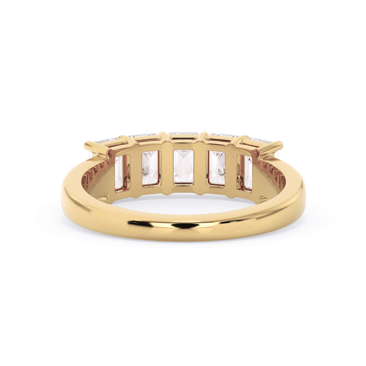 A picture of a five stone diamond wedding ring with emerald cut diamonds that are shared prong set in yellow gold on a white background with a view of the underside of the ring.