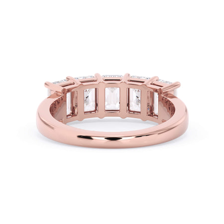 A picture of a five stone diamond wedding ring with emerald cut diamonds that are shared prong set in rose gold on a white background with a view of the underside of the ring.