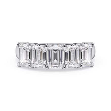 A picture of a five stone diamond wedding ring with emerald cut diamonds that are shared prong set in white gold or platinum on a white background with the ring facing forward, lying down.