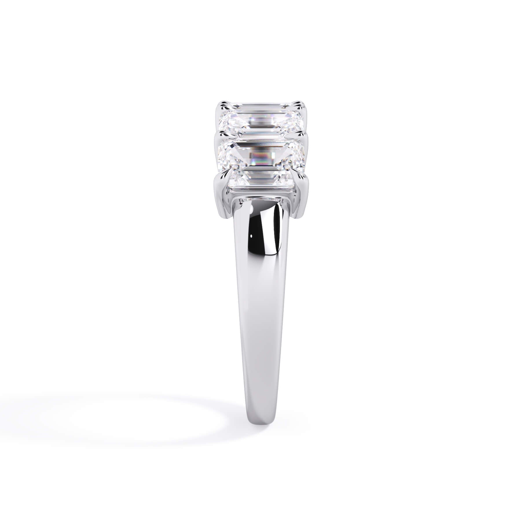 A picture of a five stone diamond wedding ring with emerald cut diamonds that are shared prong set in white gold or platinum on a white background with a side profile view.