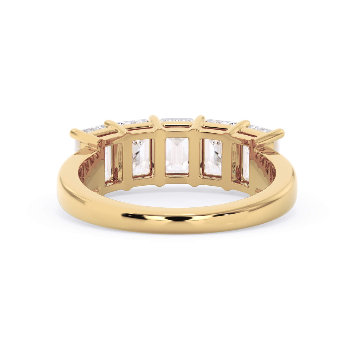 A picture of a five stone diamond wedding ring with emerald cut diamonds that are shared prong set in yellow gold on a white background with a view of the underside of the ring.