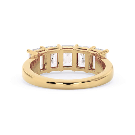 A picture of a five stone diamond wedding ring with emerald cut diamonds that are shared prong set in yellow gold on a white background with a view of the underside of the ring.