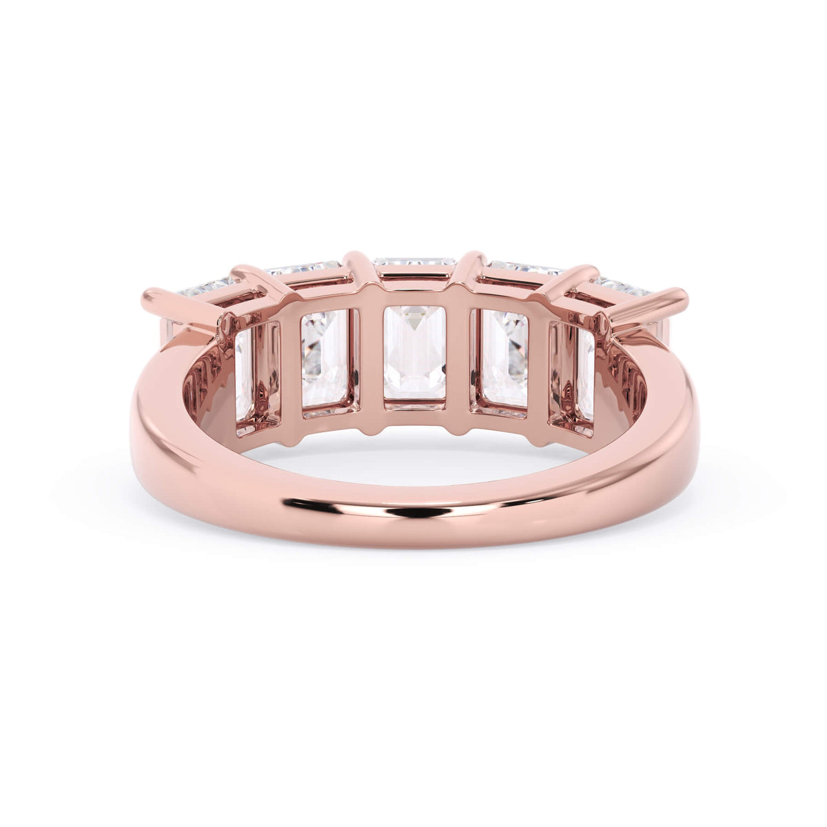 A picture of a five stone diamond wedding ring with emerald cut diamonds that are shared prong set in rose gold on a white background with a view of the underside of the ring.