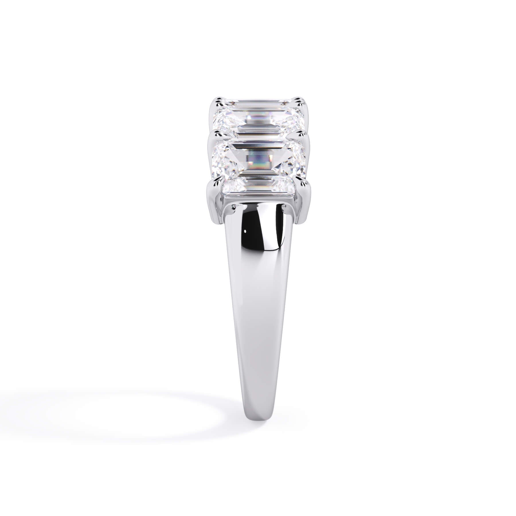 A picture of a five stone diamond wedding ring with emerald cut diamonds that are shared prong set in white gold or platinum on a white background with a side profile view.