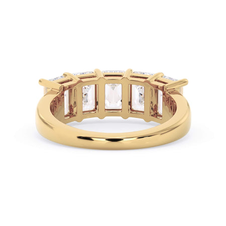 A picture of a five stone diamond wedding ring with emerald cut diamonds that are shared prong set in yellow gold on a white background with a view of the underside of the ring.