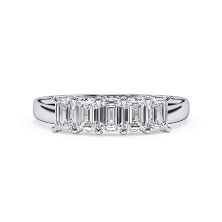 A picture of a five stone diamond wedding ring with emerald cut diamonds that are u prong set in white gold or platinum on a white background with the ring facing forward, lying down.