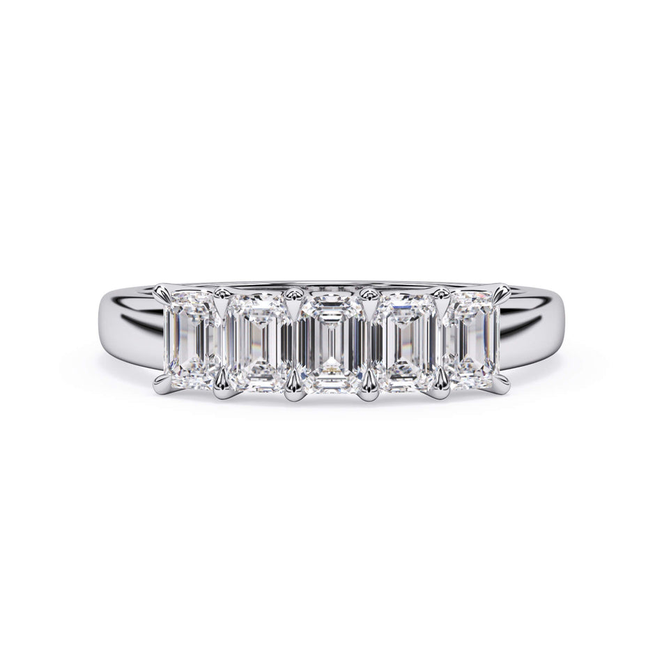 A picture of a five stone diamond wedding ring with emerald cut diamonds that are u prong set in white gold or platinum on a white background with the ring facing forward, lying down.