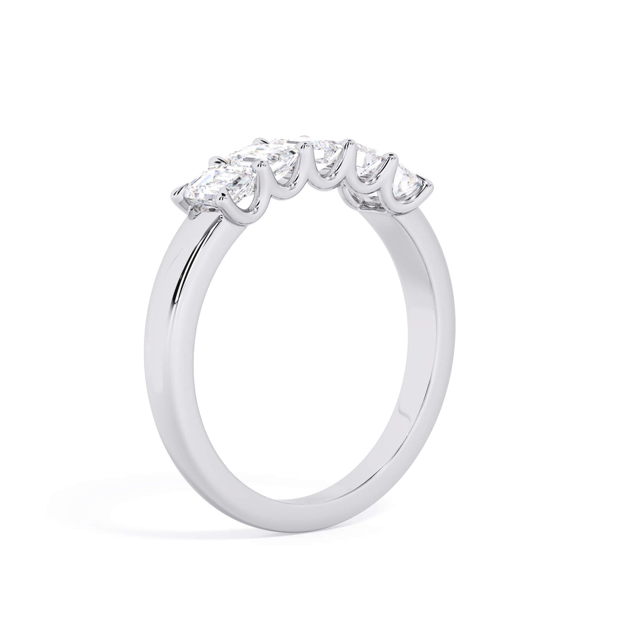 A picture of a five stone diamond wedding ring with emerald cut diamonds that are u prong set in white gold or platinum on a white background with a slightly angled, through the finger view.