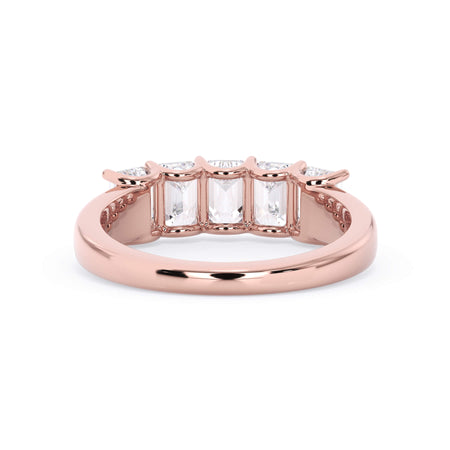 A picture of a five stone diamond wedding ring with emerald cut diamonds that are u prong set in rose gold on a white background with a view of the underside of the ring.