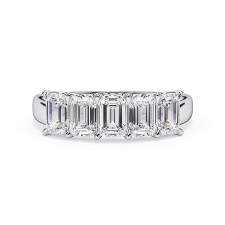 A picture of a five stone diamond wedding ring with emerald cut diamonds that are u prong set in white gold or platinum on a white background with the ring facing forward, lying down.
