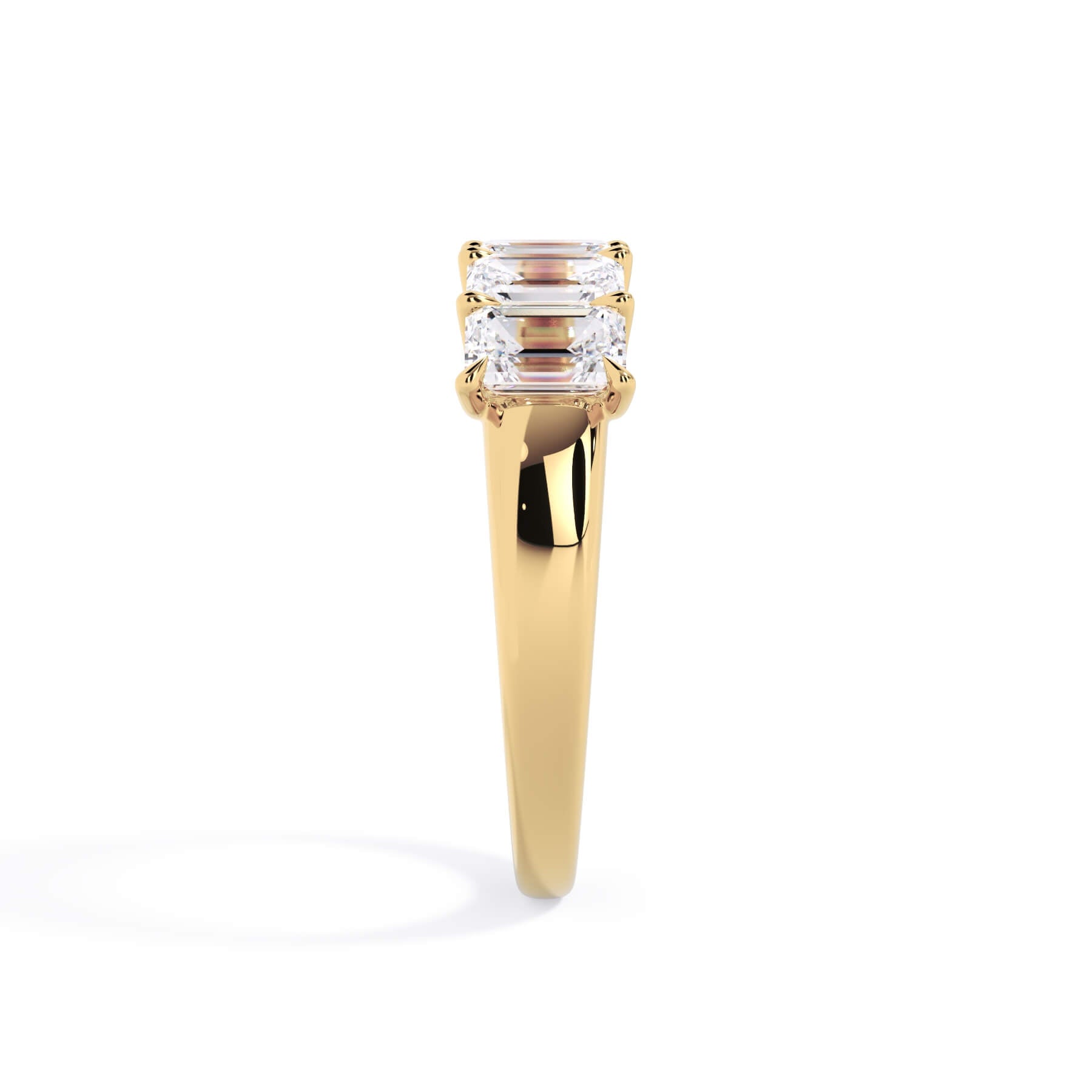 A picture of a five stone diamond wedding ring with emerald cut diamonds that are u prong set in yellow gold on a white background with a side profile view.
