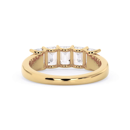A picture of a five stone diamond wedding ring with emerald cut diamonds that are u prong set in yellow gold on a white background with a view of the underside of the ring.