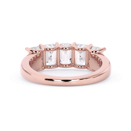A picture of a five stone diamond wedding ring with emerald cut diamonds that are u prong set in rose gold on a white background with a view of the underside of the ring.