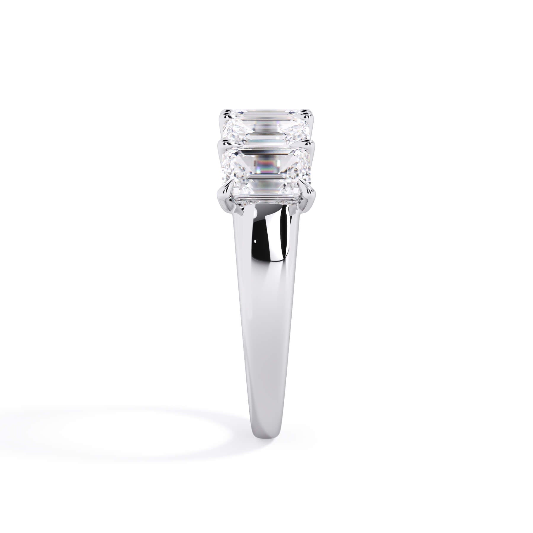 A picture of a five stone diamond wedding ring with emerald cut diamonds that are u prong set in white gold or platinum on a white background with a side profile view.