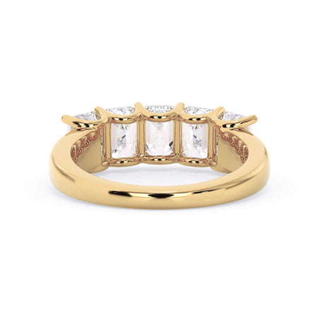 A picture of a five stone diamond wedding ring with emerald cut diamonds that are u prong set in yellow gold on a white background with a view of the underside of the ring.