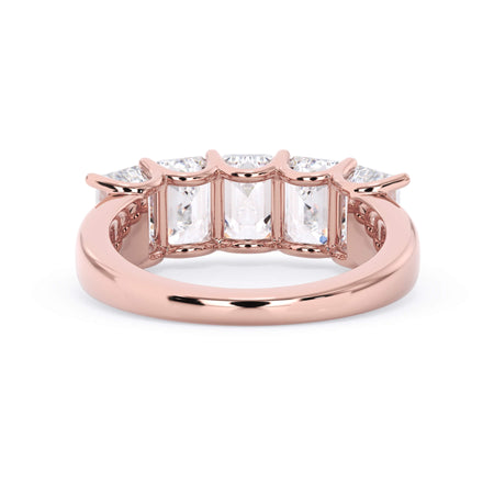 A picture of a five stone diamond wedding ring with emerald cut diamonds that are u prong set in rose gold on a white background with a view of the underside of the ring.