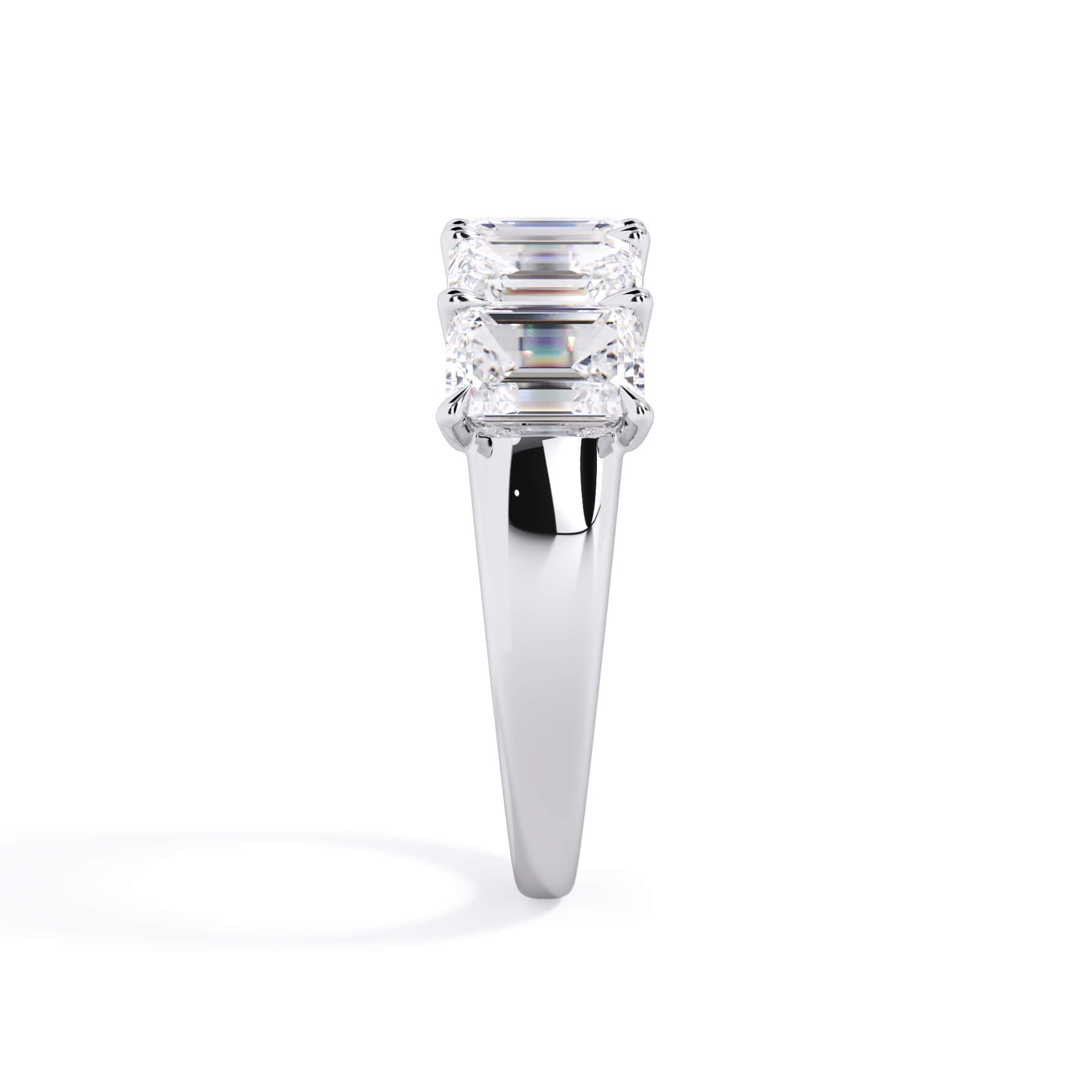 A picture of a five stone diamond wedding ring with emerald cut diamonds that are u prong set in white gold or platinum on a white background with a side profile view.