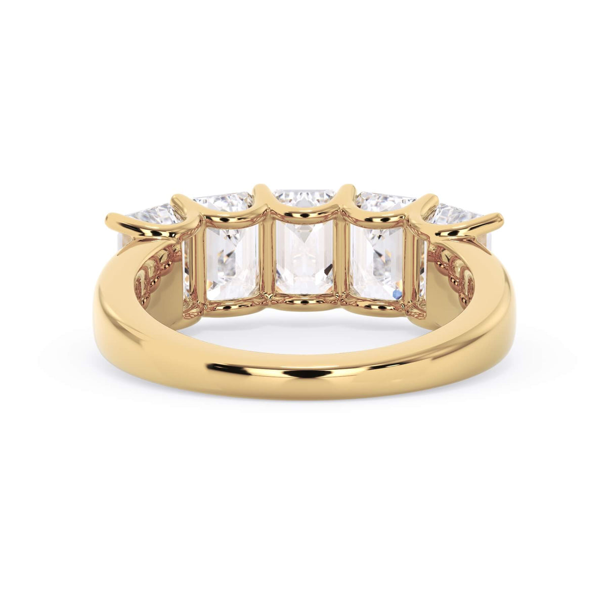 A picture of a five stone diamond wedding ring with emerald cut diamonds that are u prong set in yellow gold on a white background with a view of the underside of the ring.