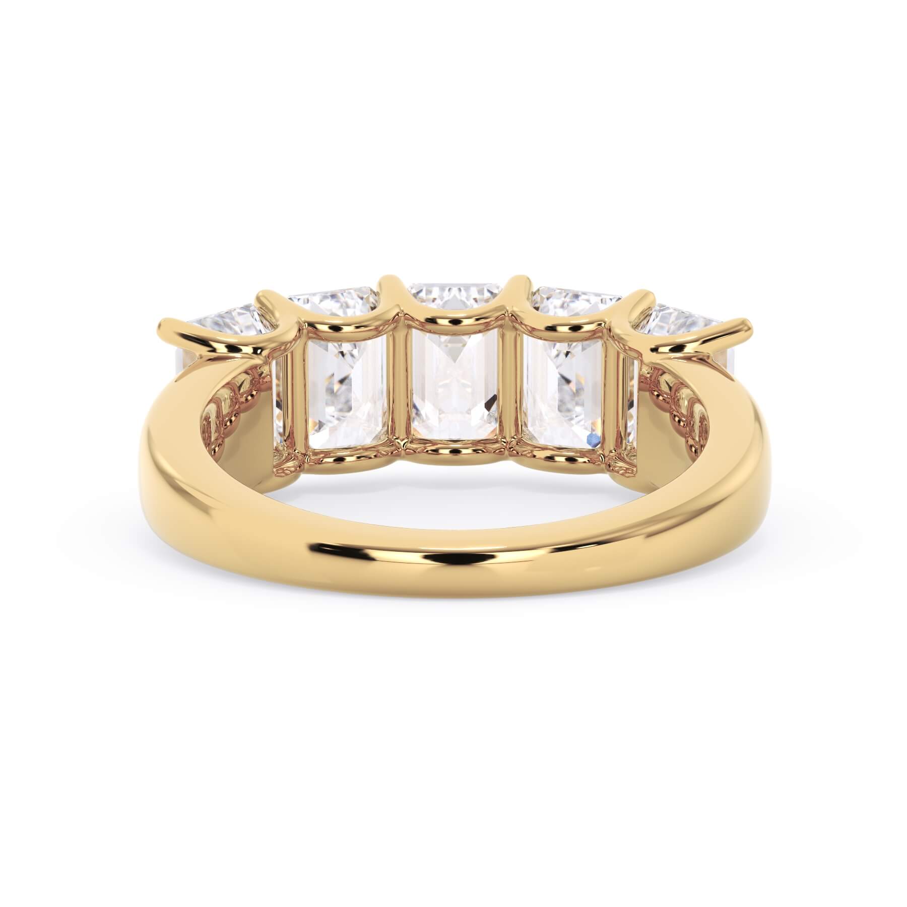 A picture of a five stone diamond wedding ring with emerald cut diamonds that are u prong set in yellow gold on a white background with a view of the underside of the ring.