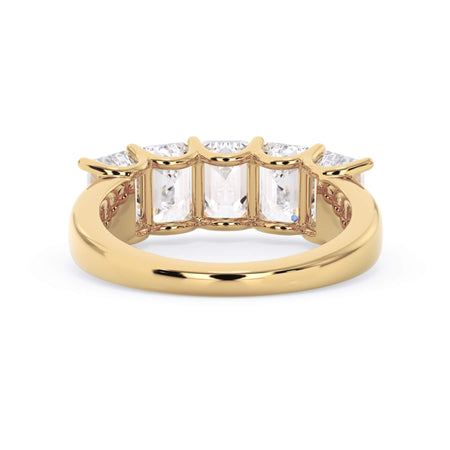 A picture of a five stone diamond wedding ring with emerald cut diamonds that are u prong set in yellow gold on a white background with a view of the underside of the ring.