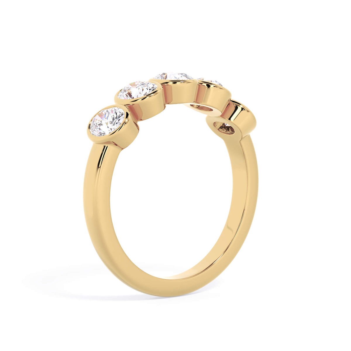 A picture of a five stone diamond wedding ring with oval shape diamonds that are bezel set in yellow gold on a white background with a slightly angled, through the finger view.