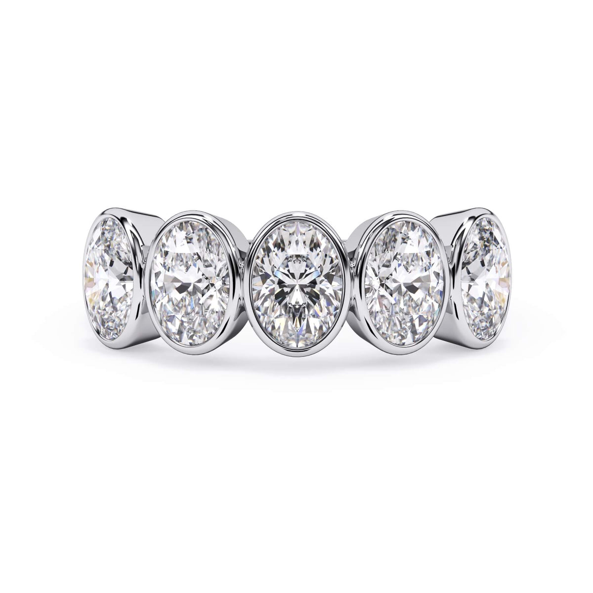 A picture of a five stone diamond wedding ring with oval shape diamonds that are bezel set in white gold or platinum on a white background with the ring facing forward, lying down.