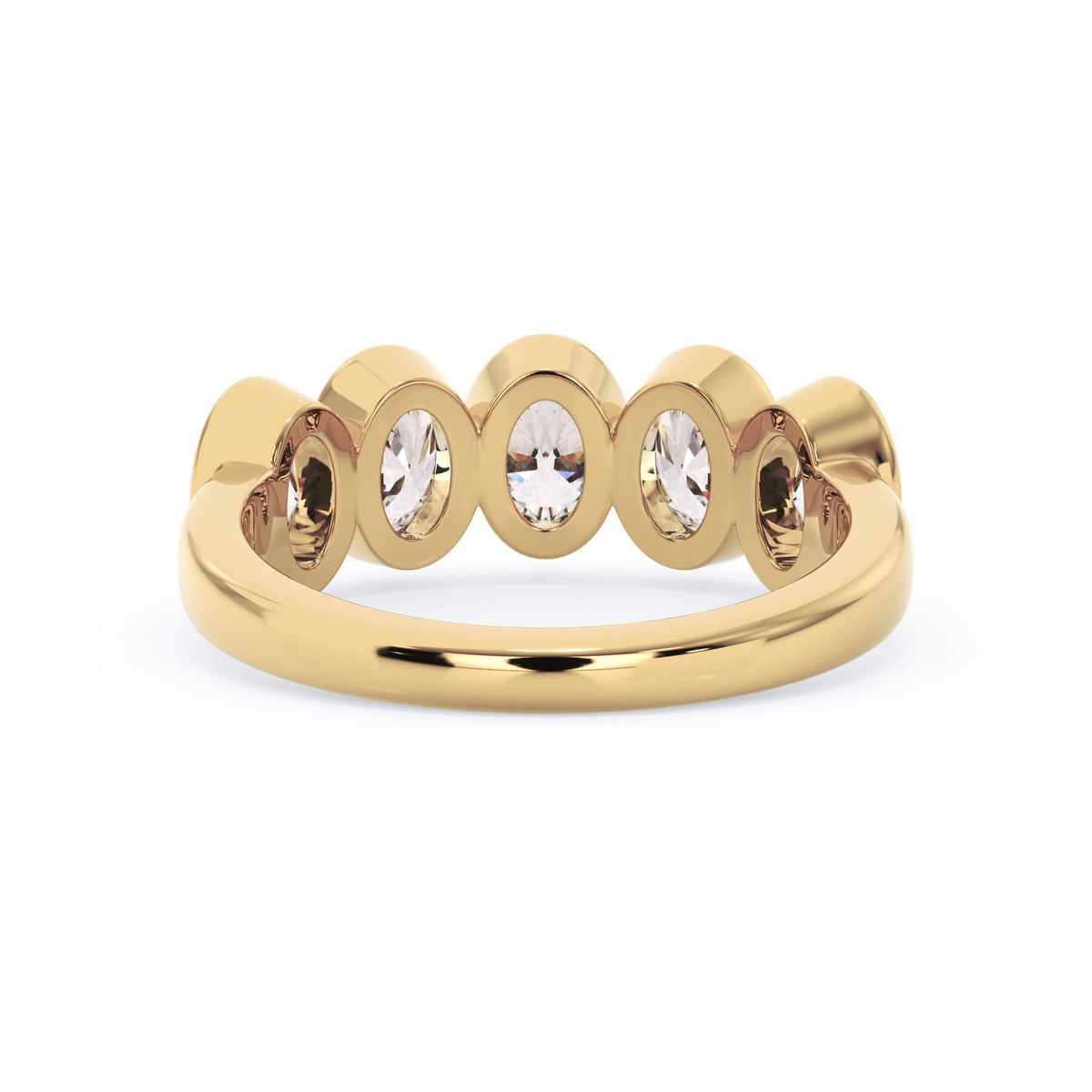 A picture of a five stone diamond wedding ring with oval shape diamonds that are bezel set in yellow gold on a white background with a view of the underside of the ring.