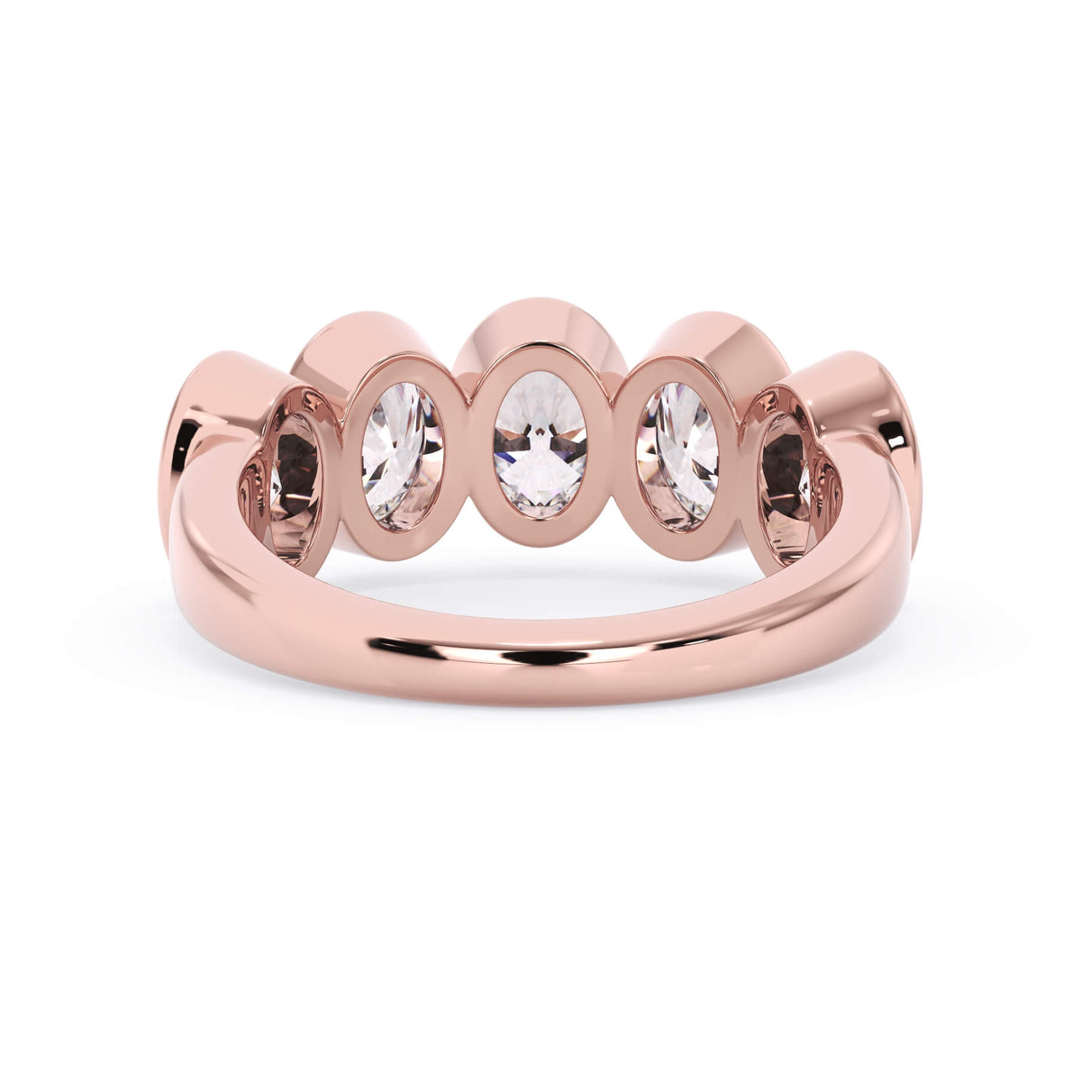 A picture of a five stone diamond wedding ring with oval shape diamonds that are bezel set in rose gold on a white background with a view of the underside of the ring.