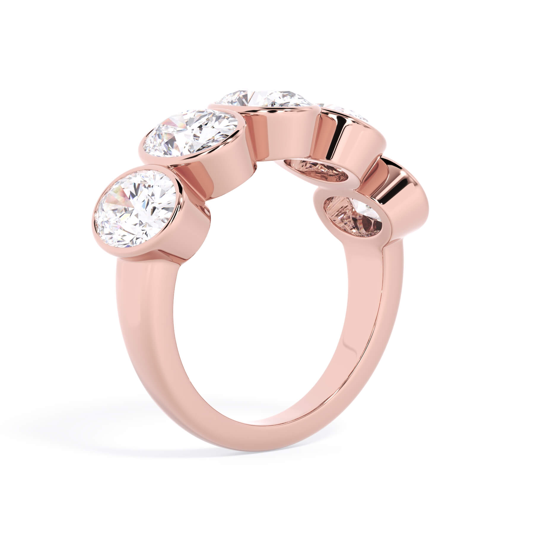 A picture of a five stone diamond wedding ring with oval shape diamonds that are bezel set in rose gold on a white background with a slightly angled, through the finger view.