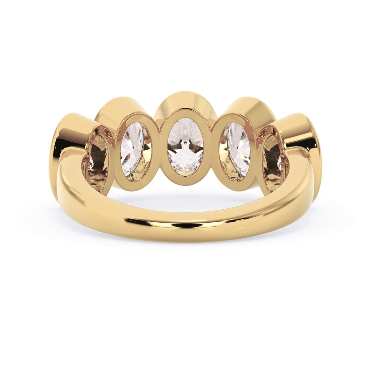 A picture of a five stone diamond wedding ring with oval shape diamonds that are bezel set in yellow gold on a white background with a view of the underside of the ring.