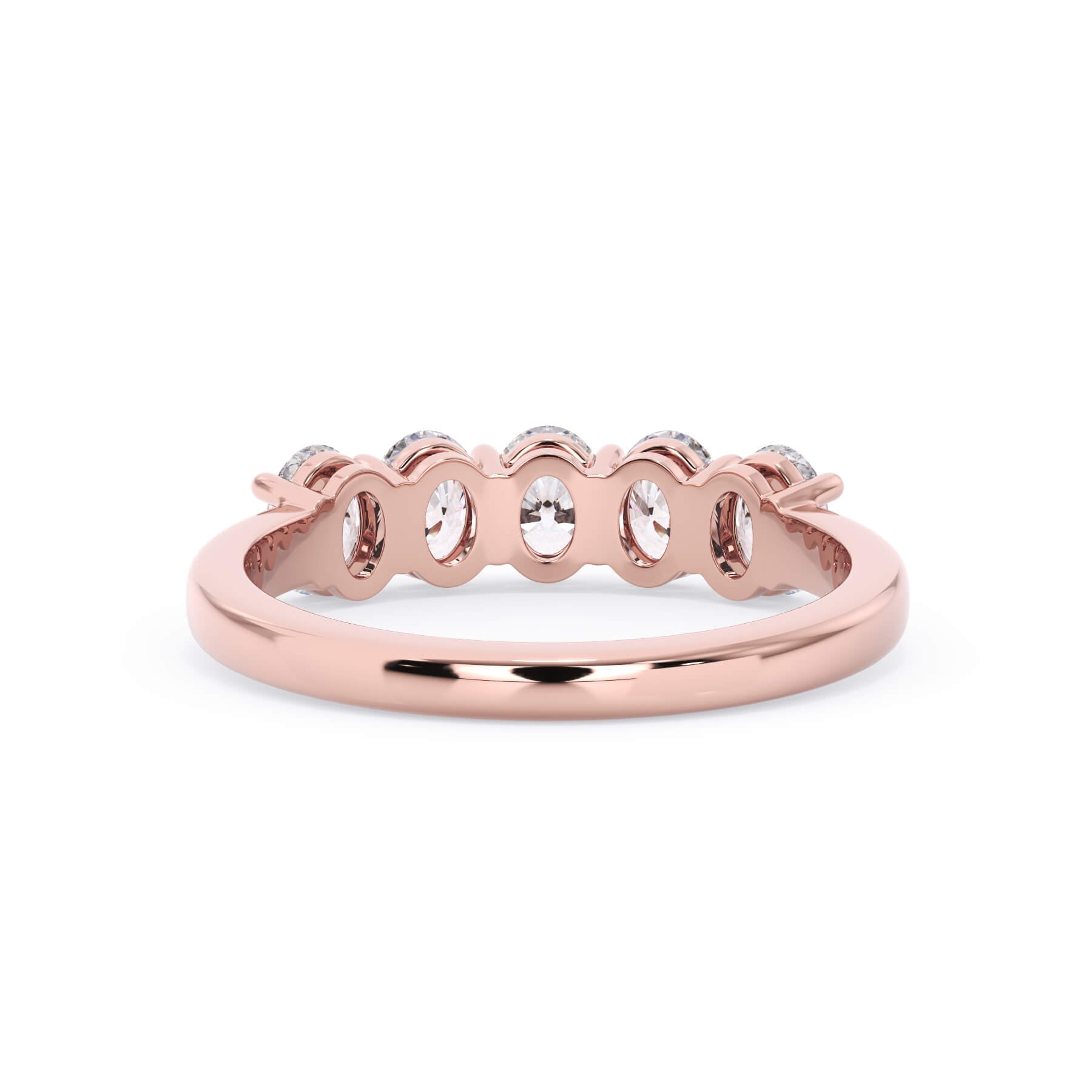 A picture of a five stone diamond wedding ring with oval shape diamonds that are shared prong set in rose gold on a white background with a view of the underside of the ring.