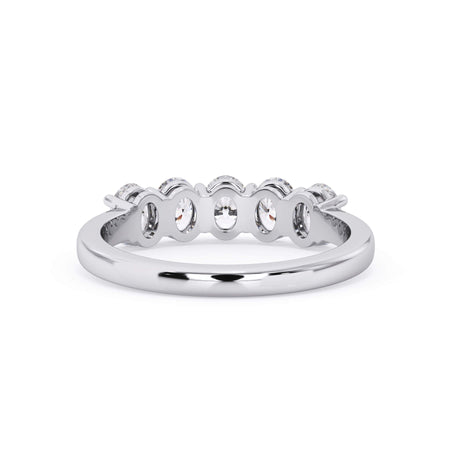 A picture of a five stone diamond wedding ring with oval shape diamonds that are shared prong set in white gold or platinum on a white background with a view of the underside of the ring.