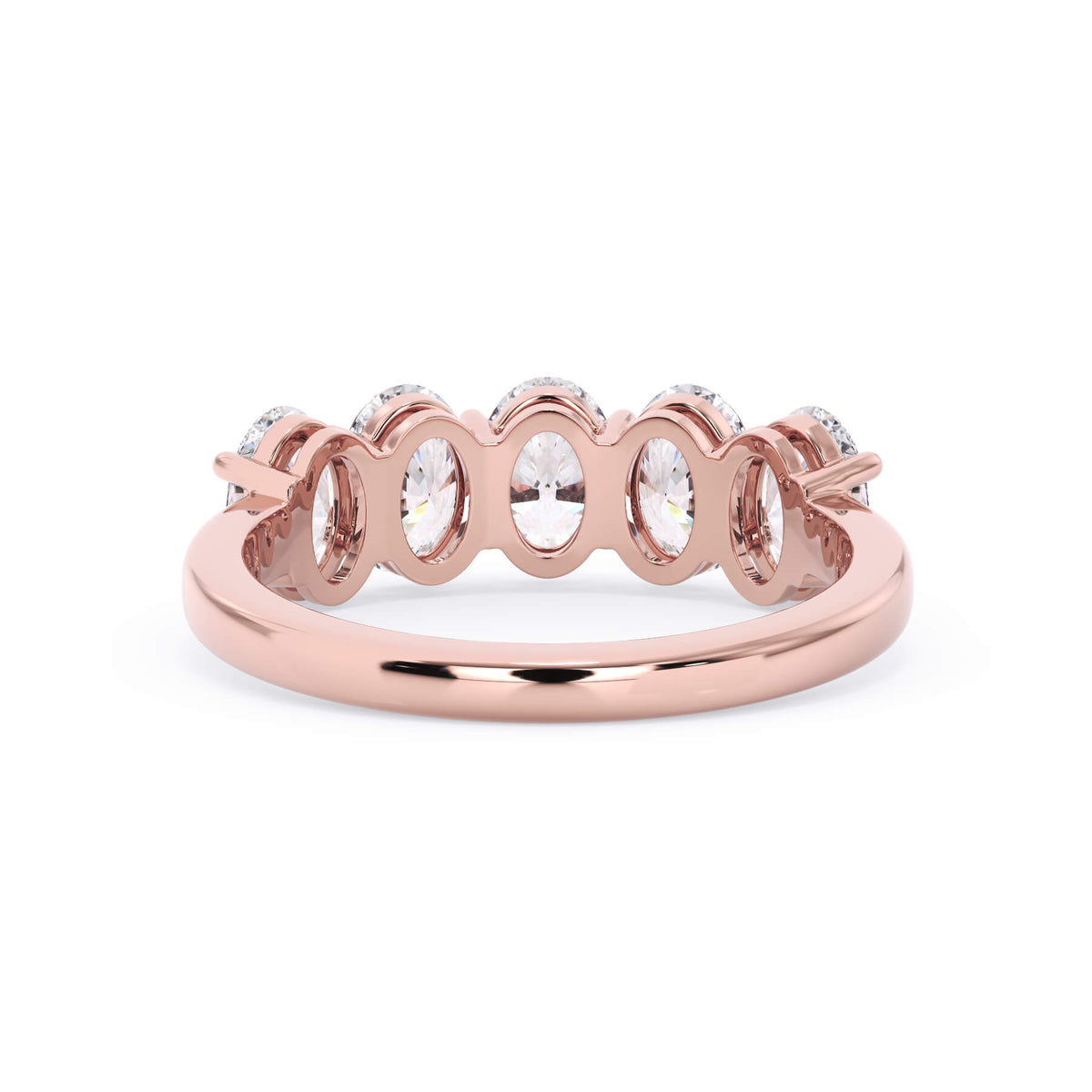 A picture of a five stone diamond wedding ring with oval shape diamonds that are shared prong set in rose gold on a white background with a view of the underside of the ring.