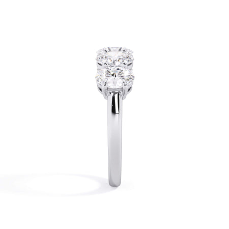 A picture of a five stone diamond wedding ring with oval shape diamonds that are shared prong set in white gold or platinum on a white background with a side profile view.