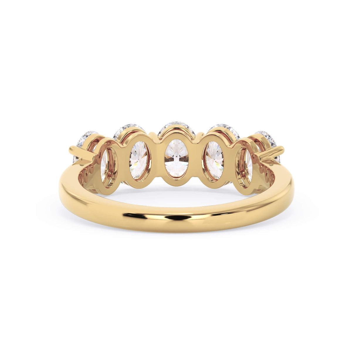 A picture of a five stone diamond wedding ring with oval shape diamonds that are shared prong set in yellow gold on a white background with a view of the underside of the ring.