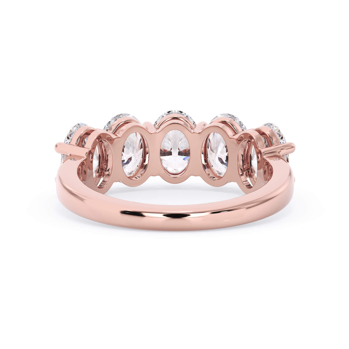 A picture of a five stone diamond wedding ring with oval shape diamonds that are shared prong set in rose gold on a white background with a view of the underside of the ring.